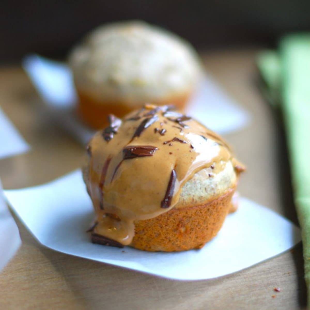 Peanut butter banana flax muffin on a piece of parchment paper.