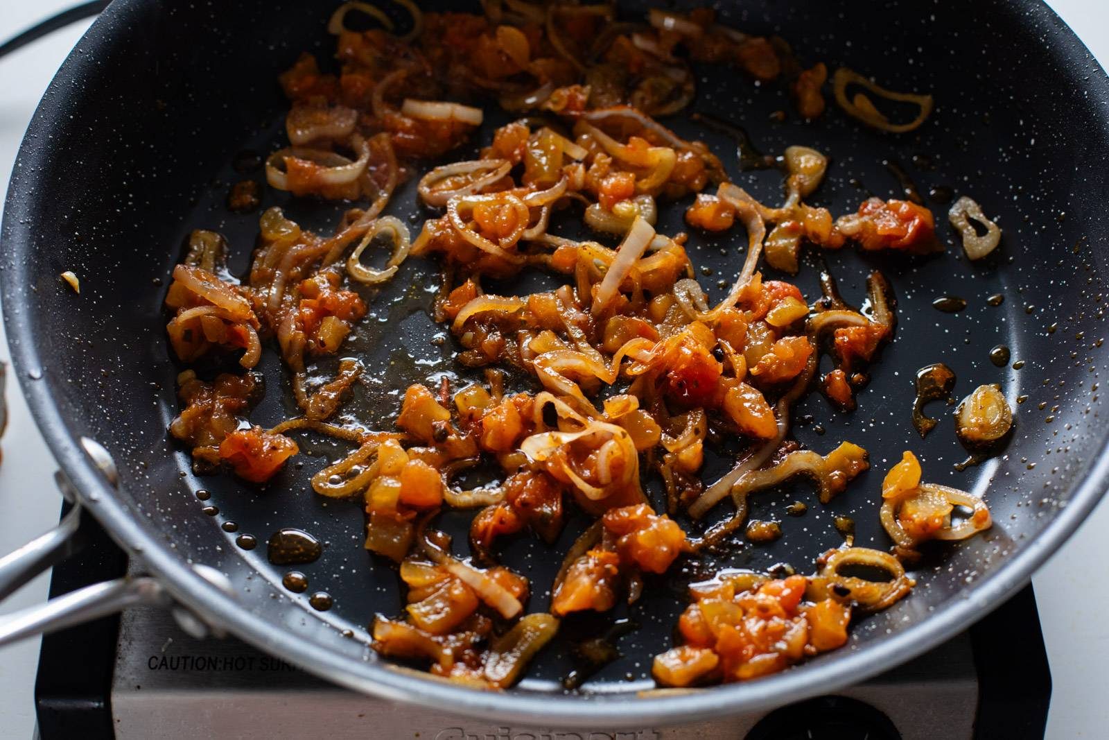 Cooking shallots in a skillet.