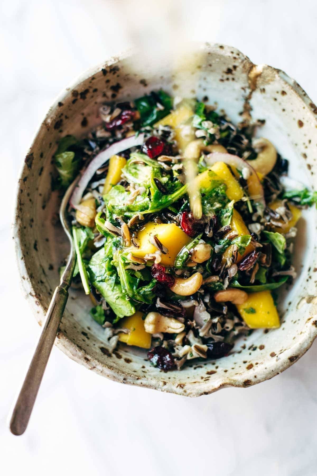 Easy Thanksgiving Salad - arugula, wild rice, cashews, dried cranberries, red onions, and a lemon dressing that shakes up easily in a jar. | pinchofyum.com Easy Thanksgiving Salad - arugula, wild rice, cashews, dried cranberries, red onions, and a lemon dressing that shakes up easily in a jar. | pinchofyum.com