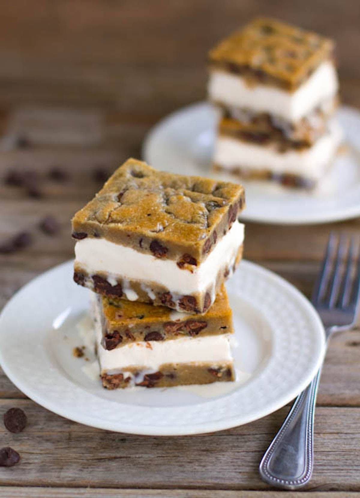 Chocolate chip cookie ice cream bars on plates.